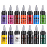 Stigma tattoo ink 15ml set, showing a wide range of vibrant colors including purple, red, orange, blue, green, yellow, white, and black